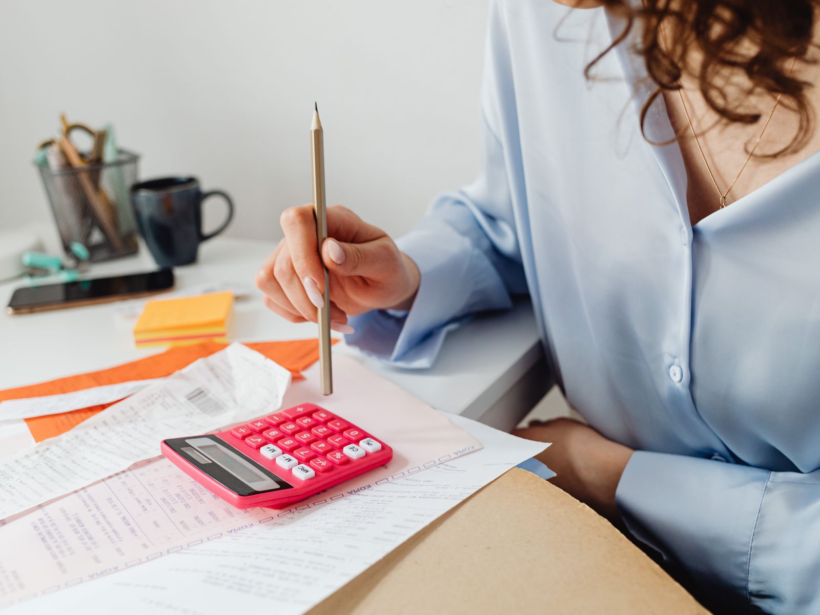 Professional bookkeeping workspace with laptop showing financial dashboards